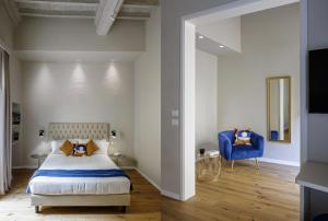 a bedroom with a bed and a blue chair at Dimora72 in Florence