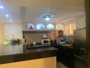 a kitchen with a counter top and a refrigerator at Riad jmiaa in Marrakesh