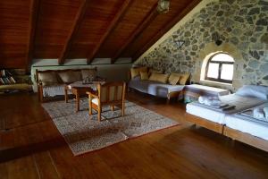 a large living room with a stone wall at Elpida Country House -Paleochora-Anidri in Palaiochora