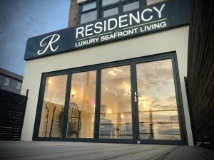 a restaurant with a sign on the front of a building at RESIDENCY LUXURY SEAFRONT HOTEL in Blackpool