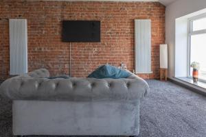 a couch in a room with a brick wall at RESIDENCY LUXURY SEAFRONT HOTEL in Blackpool