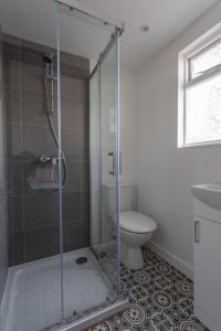 a bathroom with a glass shower with a toilet at RESIDENCY LUXURY SEAFRONT HOTEL in Blackpool
