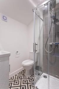 a bathroom with a toilet and a glass shower at RESIDENCY LUXURY SEAFRONT HOTEL in Blackpool