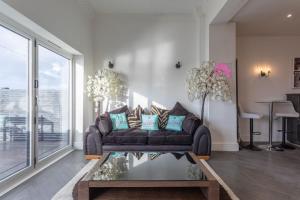 a living room with a couch and a table at RESIDENCY LUXURY SEAFRONT HOTEL in Blackpool