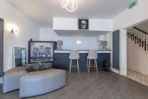 a living room with two stools and a bar at RESIDENCY LUXURY SEAFRONT HOTEL in Blackpool