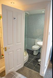 a bathroom with a toilet and a sink at Weymouth Bay Hotel in Weymouth