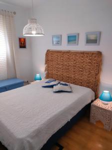 a bedroom with a large bed with two pillows on it at Casa de Praia in Vila do Conde