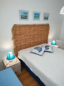 a bedroom with a bed with two pillows on it at Casa de Praia in Vila do Conde