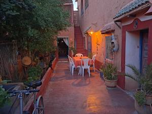 a patio with a table and chairs in an alley at DAR JOUD in Tabourakht