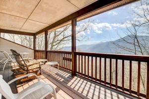 a balcony with chairs and a view of the mountains at Stunning Maggie Valley Getaway with Decks, Fire Pit! in Maggie Valley