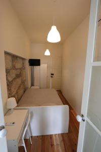a room with a bed and a table and a window at Rustic Silent Ensuites - Shared Kitchen - Self check in in Porto
