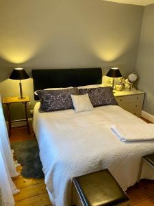 a bedroom with a large white bed with pillows at River walk . Shrewsbury.Shropshire.With parking. in Shrewsbury