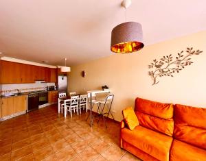 a living room with a couch and a kitchen at Apartment in La Tejita 2 in La Tejita