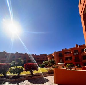 a view of a city with buildings and the sun at Apartment in La Tejita 2 in La Tejita