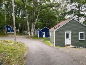 a row of small houses on the side of a road at Cheerful 1 Bedroom Cottage Close to Everything 2 in Edgecomb