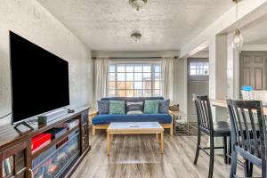 a living room with a blue couch and a tv at Cake by the Ocean in Lincoln City