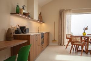 a kitchen with a table and a dining room at Vila Rodrigues in Lisbon