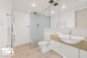 a bathroom with a toilet and a sink and a shower at Mowamba E5 in Thredbo