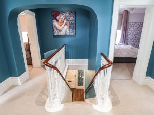 a hallway with a glass table and blue walls at 105 Spilsby Road in Boston