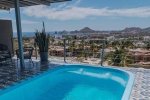 a blue swimming pool with a view of the city at CASA ZARAPE, 3BR, 2BT, 6 PAX. in El Pueblito