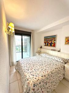 een slaapkamer met een bed en een raam bij Apartamento con terraza Edificio Tamarindo en Cala de Finestrat in Cala de Finestrat