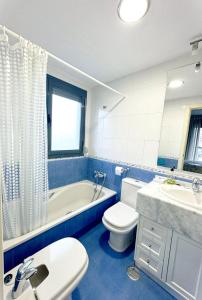 een badkamer met een bad, een toilet en een wastafel bij Apartamento con terraza Edificio Tamarindo en Cala de Finestrat in Cala de Finestrat