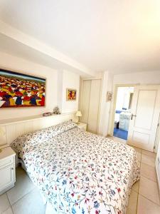 1 dormitorio con 1 cama y una pintura en la pared en Apartamento con terraza Edificio Tamarindo en Cala de Finestrat, en Cala de Finestrat