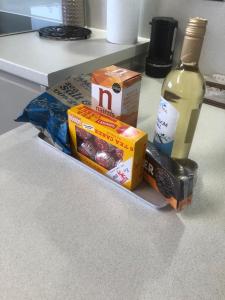 a counter with a bottle of wine and a box of food at Two Chimneys in Upper Bayble
