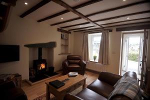 a living room with a couch and a fireplace at No 2 The Forge Coniston in Coniston