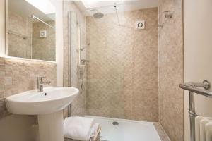 a bathroom with a sink and a shower at Westwood Cottage in Longniddry +11 photos