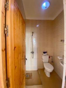 a bathroom with a toilet and a shower at Amadel Surf & beach4 in Imsouane