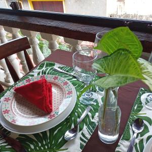 a table with a plate with a cake on it at Pousada Renascer in Mangaratiba +27 photos