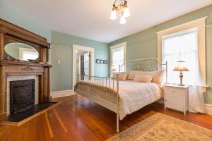 a bedroom with a bed and a fireplace at Ellerslie Bed and Breakfast in Fanny Bay