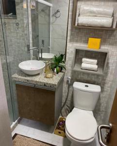 a bathroom with a toilet and a sink at MAKAIBA FLATS De Luxo in Porto De Galinhas