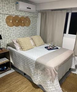 a bedroom with a bed with a tray on it at MAKAIBA FLATS De Luxo in Porto De Galinhas