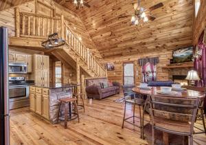 a log cabin kitchen with a table and chairs at Wilderness Lodge, Hot Tub, Pool Table, Pool Access, WIFIeach paid day in Sevierville