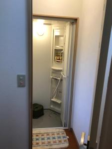 an open door to a kitchen with a refrigerator at Daigo House in Daigo