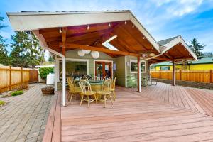 a wooden deck with a table and chairs on it at Cedar River Retreat in Renton