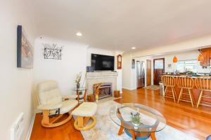 a living room with a fireplace and a table and chairs at Cedar River Retreat in Renton