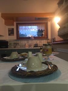 a table with two tea cups and a plate on it at B&B Lo Tatà in Fenis