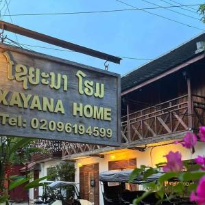 a sign for a hawaiian home with pink flowers at Xayana Home Villas in Luang Prabang