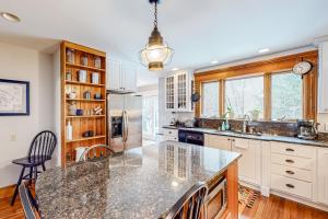 a kitchen with a large island with a counter top at Lamoille Valley Manor in Jeffersonville