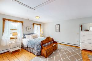 a bedroom with a bed and a dresser at Lamoille Valley Manor in Jeffersonville