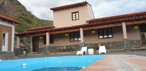 a house with a swimming pool in front of a house at Las Piedritas Cafayate in Cafayate