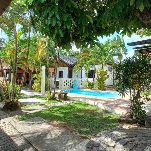 a villa with a swimming pool in a resort at Pousada Mares de Stella in Salvador