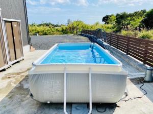 a hot tub sitting on the porch of a house at AZ Hotel in Amami - Villa with private outdoor Jacuzzi in Amami