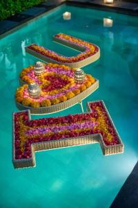 a display of flowers in a swimming pool at Gaing Mas Jimbaran Villas by Gaing Mas Group in Jimbaran
