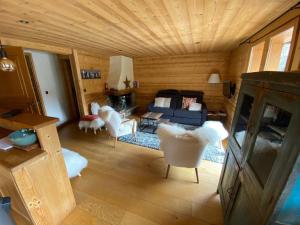a living room with a couch and some chairs at Appartement La Clusaz, 4 pièces, 8 personnes - FR-1-459-189 in La Clusaz