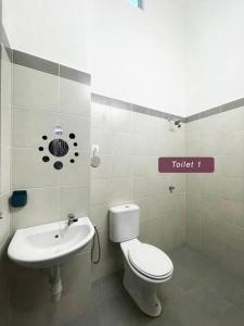 a bathroom with a toilet and a sink at ASFA Guesthouse in Alor Setar