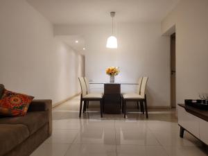 a living room with a dining room table and chairs at Apartamento em Niterói Excelente Localização - Boa Viagem in Niterói